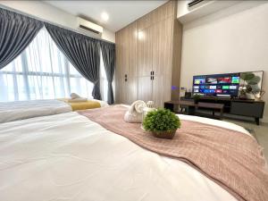a bedroom with a large bed and a flat screen tv at SEPANG CIRCUIT # Bell Suite Twin King Sepang Kota Warisan KLIA - Near KLIA in Sepang +17 photos