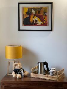 a teddy bear sitting on a table with a lamp at Le Mas de Mirabel in Mirabel-aux-Baronnies