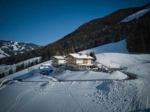 a house on top of a snow covered mountain at Am Mitteregghof in Saalbach Hinterglemm