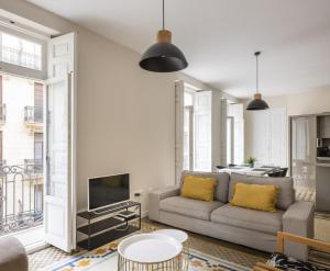 a living room with a couch and a fireplace at Macflats Ayuntamiento in Valencia