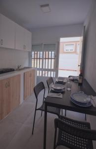 a kitchen with a table and chairs in a room at Apartamento in Almería