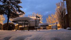 a group of chairs covered in snow in a yard at La Vereda ONLY ADULTS in Mora de Rubielos