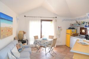 a living room with a couch and a table at villa fronte mare in Cannigione