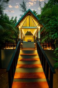 a stairway leading to a yellow building with a pathway at La La Land Resort Goa by Spicy Mango in Palolem