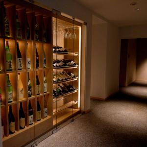 a wine cellar with a display case full of wine bottles at Hakone Gora Byakudan in Hakone +41 photos