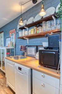 a kitchen with a counter with a microwave and a sink at Stockholms home away from home in Stockholm