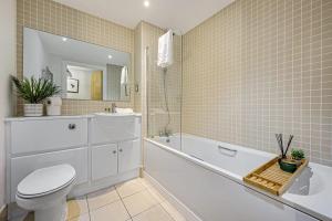 a bathroom with a toilet and a tub and a sink at Host & Stay - Standish Street Abode in Liverpool
