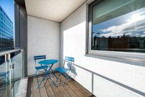 two chairs and a table on a balcony with a window at Host & Stay - Standish Street Abode in Liverpool