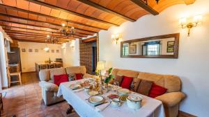 a living room with a table and chairs at Fuente de la Gitana Rute by Ruralidays in Rute