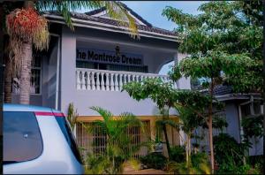 a white building with a sign that reads the warehouse dream at Mt Pleasant B'n'B in Harare