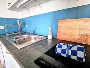 a kitchen with a sink and a counter top at La Bulle Bleue - Parking-Terrasse-aéoport-MEET in Blagnac