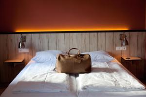 a purse sitting on top of a bed at Dock1 in Regensburg