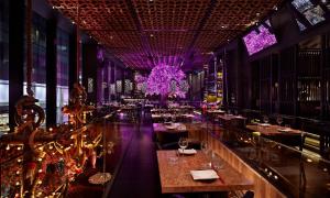 a restaurant with purple lighting and tables and chairs at St Martin's Place 2 Bed Bham City with free parking in Birmingham