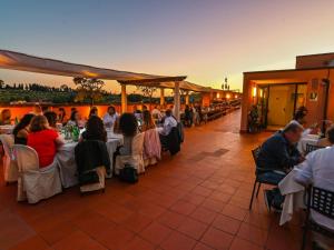 a group of people sitting at tables at a restaurant at Chocohotel in Perugia