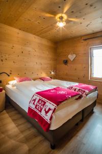 a bedroom with a large bed in a wooden room at Appartamento Abete in Livigno