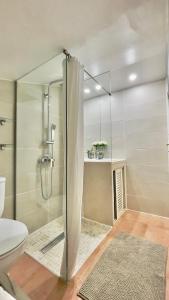 a bathroom with a shower stall and a toilet at Lo Exclusive Lisboa - Apartament with terrace and golf view in Charneca +36 photos
