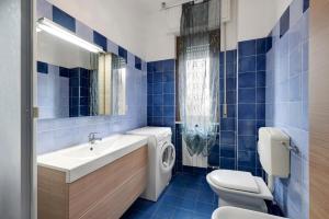 La salle de bains est pourvue de carrelage bleu, de toilettes et d'un lavabo. dans l'établissement Appartamento Le Vele, à Borghetto Santo Spirito 18 autres photos