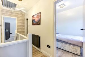 a hallway leading to a bedroom with a bed at Beauty Close to Coast, Stunning interior, By Air Premier in Newhaven