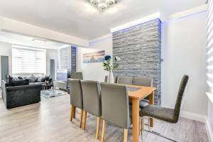 a dining room and living room with a table and chairs at Beauty Close to Coast, Stunning interior, By Air Premier in Newhaven