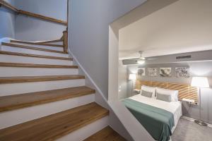 a bedroom with a bed and a staircase at Luxurious apartment in Kolonaki in Athens