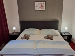 a bedroom with a large bed with two pillows on it at Hotel am Hafen in Braunschweig