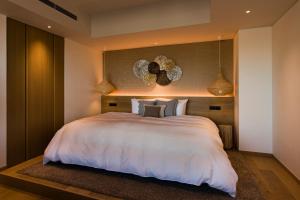 Un pat sau paturi într-o cameră la MALIBU HOTEL
