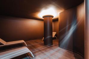 a pole in a room with a light on the wall at Porto Covo Praia Hotel & SPA in Porto Covo