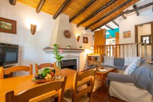 a living room with a table and a dining room at El Chorro Villas Casa Rosaleda in El Chorro
