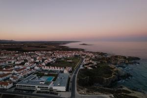 an aerial view of a town next to the ocean at Porto Covo Praia Hotel & SPA in Porto Covo