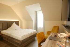 Postel nebo postele na pokoji v ubytování Hotel Sonne Rudersberg