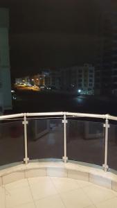a view of a city at night from a balcony at KONYAALTI HURMA 1+1 EŞYALI DAİRE TAMAMI in Antalya