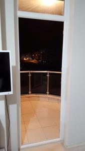 a balcony with a view of a city at night at KONYAALTI HURMA 1+1 EŞYALI DAİRE TAMAMI in Antalya
