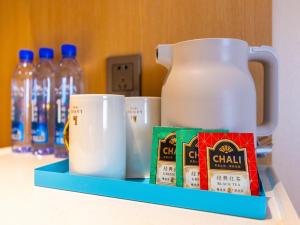 a shelf with a cup of coffee and some milk at LanOu Hotel Lanzhou Zhengning Road Night Market in Lanzhou