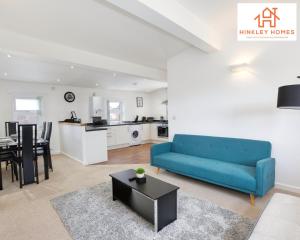 a living room with a blue couch and a table at Flawless - City Centre - Free Parking - HPC - 5 - By Hinkley Homes Short Lets & Serviced Accommodation in Bridgwater