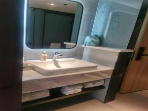 a bathroom with a sink and a mirror at LanOu Hotel Tianshui Bus Terminal Station in Tianshui