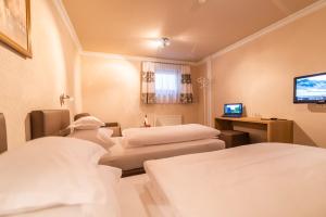 Postelja oz. postelje v sobi nastanitve Hotel Garni Apart TINA