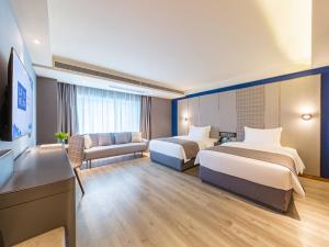 貴陽的住宿－贵阳北京西路世纪城兰欧酒店，酒店客房,设有两张床和一张沙发
