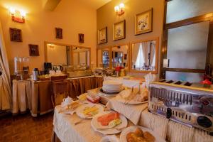 a buffet with plates of food on a table at The Amariah Hotel & Apartments Mikocheni in Dar es Salaam