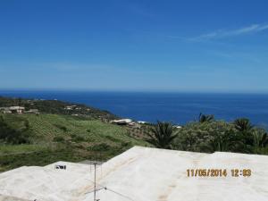 a view of the ocean from the top of a hill at I Dammusi di Punta Karace in Tracino