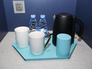 a group of three coffee cups and bottles of water at LanOu Hotel Heze Mudan District University Town in Heze