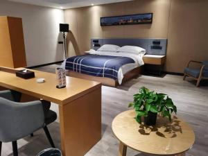a hotel room with a bed and a desk at LanOu Hotel Lianyungang Donghai Anfeng Town in Donghai