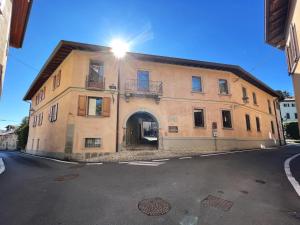a large stone building with an archway on a street at Il Portico - 1711 Luxury Guest House in Arlate