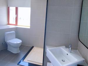 a bathroom with a toilet and a sink at LanOu Hotel Golmud Middle Bayi Road in Golmud