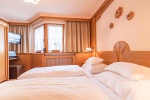 Postelja oz. postelje v sobi nastanitve Hotel Garni Apart TINA