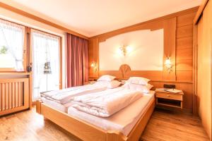 Postelja oz. postelje v sobi nastanitve Hotel Garni Apart TINA