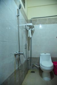 a bathroom with a shower and a toilet in it at HOTEL KING PARK in Pondicherry