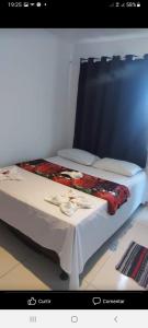 a bed in a room with a table with a white table cloth at Pousada Portico de Buzios in Armacao dos Buzios +24 photos