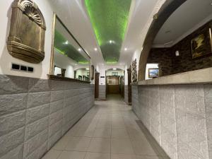 a corridor of a building with a green ceiling at Hotel de l'Aeroport in Brazzaville