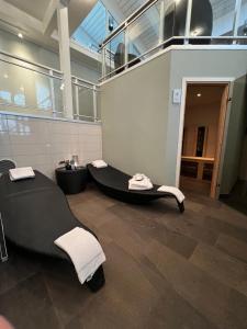 a bathroom with a black tub and a sink at Saltstraumen Hotel in Straumen