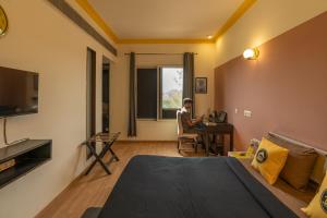 a man sitting at a desk in a hotel room at The Hosteller Delhi in New Delhi